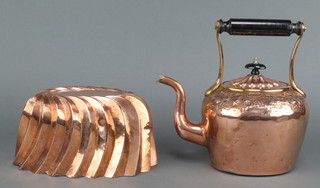 A 19th Century oval copper jelly mould 4" x 8 1/2" x 5 1/2" and a Victorian embossed copper kettle with turned ebony handle 