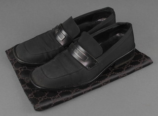 A pair of Gucci slip on fabric and leather shoes, size 38 1/2 C complete with cloth bag 
