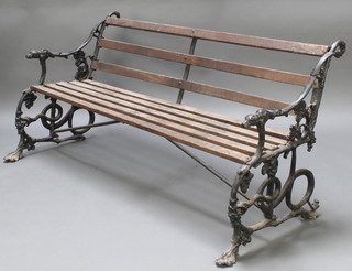 A Coalbrookdale style slatted garden bench, the pierced cast iron ends with fig leaf and lion mask decoration 30"h x 62"w x 25"d 