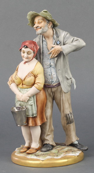 A Capodimonte group of a couple standing holding a bucket 10"