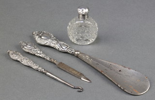 A silver mounted cut glass scent bottle and 3 silver handled implements 