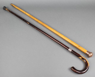 A walking cane with a 9ct yellow gold knop and a walking stick with a silver collar