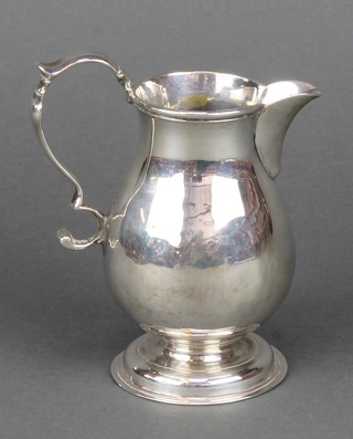 A Georgian silver cream jug of baluster form with S scroll handle, date marks rubbed 120 grams 