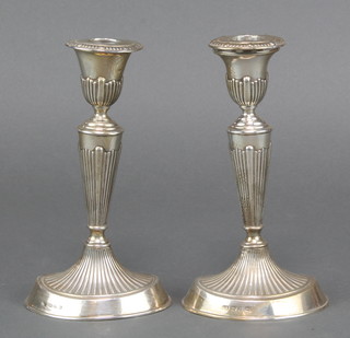 A pair of Victorian silver Adam style candlesticks with tapered stems Birmingham 1898 7 1/2" 
