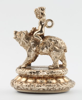 A 9ct yellow gold hard stone seal with a cupid riding a bear, gross 24 grams 