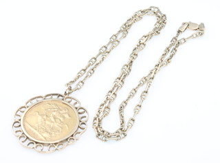 A Sovereign 1958 in a 9ct mount and chain, 7 grams 