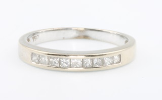 An 18ct white gold diamond set half hoop ring, size K 1/2
