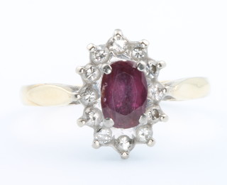 A yellow gold oval ruby and diamond cluster ring size J 