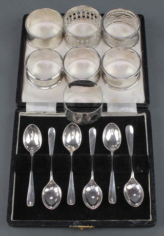 A set of 6 cased silver coffee spoons and 7 silver napkin rings 190 grams