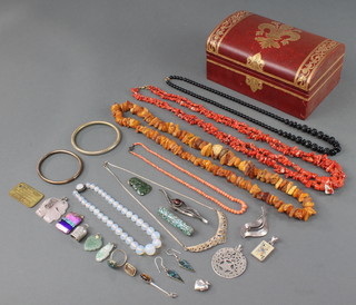 A leather jewellery box containing a quantity of Victorian and later costume jewellery  