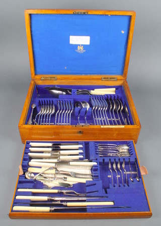 An Edwardian oak canteen containing a set of plated cutlery 