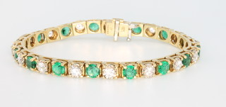 An 18ct yellow gold diamond and emerald bracelet, the brilliant cut diamonds approx. 5ct, the brilliant cut emeralds approx. 4ct, 175mm 