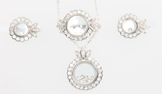 A silver and cubic zirconia pendant, earrings and ring set decorated with floating stones