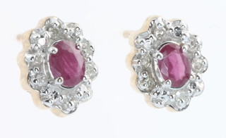 A pair of 9ct yellow gold oval ruby and diamond ear studs 