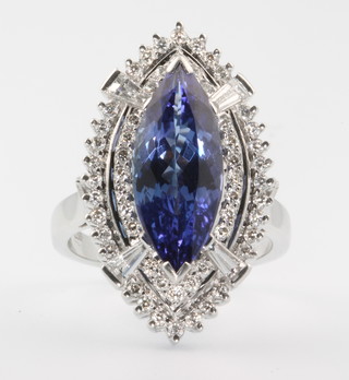 A 14ct white gold tanzanite and diamond elliptical ring, the centre stone approx 1.5ct surrounded by tapered baguette and brilliant cut diamonds approx. 5.5ct, size O 1/2