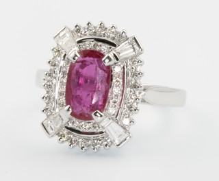 A 14ct white gold ruby and diamond Art Deco style diamond ring, the centre stone approx. 1.64ct surrounded by tapered baguette and brilliant cut diamonds approx. 1.02ct size Q