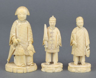 An early 20th Century carved ivory figure of a seated lady 3 1/2", a ditto of a gentleman carrying a parasol 3" and another of a lady holding a fan 3" 