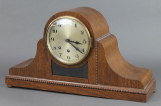 A 1930's 8 day chiming mantel clock with silvered dial and Arabic numerals contained in an oak Admiral's hat shaped case raised on bun feet (1 missing) 