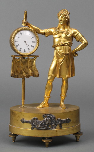 A Regency Continental table timepiece in the form of a standing centurion with banner, having an enamelled dial with Roman numerals contained in a gilt ormolu case 9 1/2" 