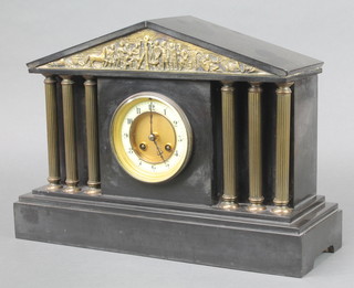 A Victorian French 8 day striking mantel clock with enamelled dial and Arabic numerals contained in a black marble architectural case and brass columns 
