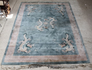 A green ground Chinese carpet decorated dragons within a Grecian key border 146" x 107" 