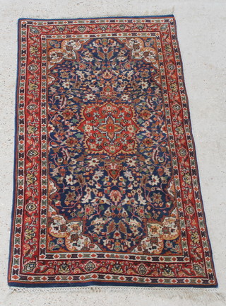 A blue ground and floral Persian rug with medallion to the centre 64" x 33 1/2"  