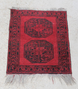 A red ground Afghan rug with 2 octagons to the centre 37" x 29" 
