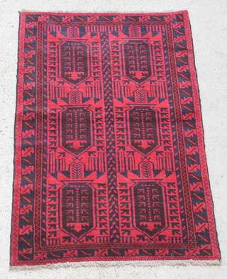 A red and blue ground Belouch rug with 6 stylised diamonds to the centre within multi-row borders 54" x 32 1/2" 
