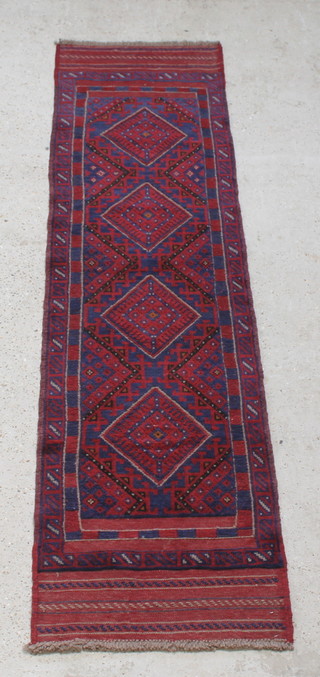 A red and blue ground Meshwani runner with 4 stylised diamonds to the centre 100" x 25 1/2" 
