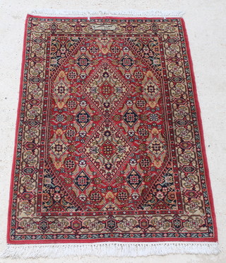 A red and blue ground Bidjar rug, signed  59" x 39" 
