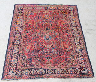 A Persian Lilian blue and red ground rug with medallion to the centre, signed, 76" x 61 1/2" 
