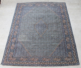 A green and blue ground Persian Tabriz carpet with central medallion 112 1/2" x 81"