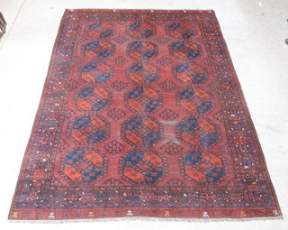 A blue and red ground Afghan carpet with 18 octagons to the centre, in wear 135" x 94 1/2" 