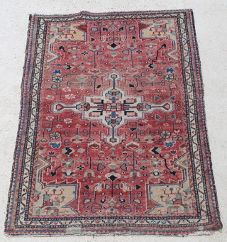 A tan and white ground Persian Brojerd rug with central medallion 64" x 43",