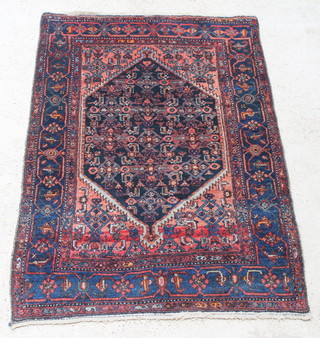 A blue and red ground Persian Malayer rug with stylised diamond to the centre 73" x 48" 