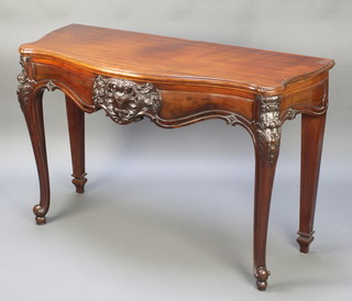 A Victorian carved mahogany hall table with heavily carved apron, raised on cabriole supports 31"h x 44"w x 20"d 