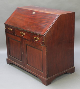 A Georgian mahogany bureau, the fall front revealing a well fitted interior above 1 long and 2 short drawers with double cupboard beneath, raised on bracket feet 39"h x 42"w x 24"d 