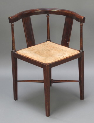 An Edwardian inlaid mahogany tub back corner chair with upholstered seat raised on square supports with X framed stretcher 