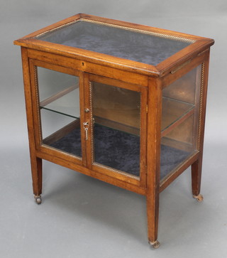 An Edwardian rectangular mahogany bijouterie cabinet, the upper section with hinged lid and velvet interior, the base fitted a cupboard enclosed by glazed panelled doors, raised on square tapering supports 30"h x 26"w x 18 1/2"d 