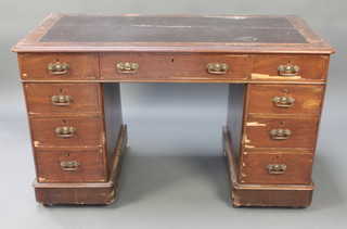 A mahogany kneehole desk with black inset writing surface above 1 long and 8 short drawers 28"h x 46"w x 24"d 