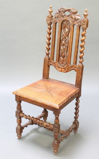 A Victorian light oak Carolean style high back hall chair with solid seat, carved cresting rail and spiral turned columns to the sides, raised on turned supports 