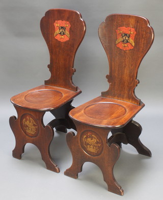 A pair of George II mahogany hall chairs with polychrome armorial decoration  depicting the Marital Arms of Hinde and Hardcastle
