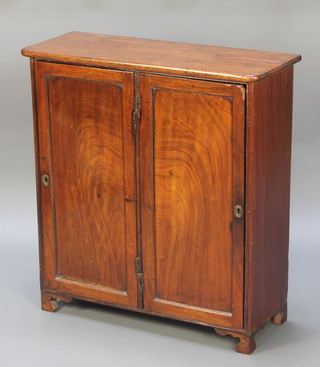 A 19th Century mahogany double cabinet, fitted shelves to one side and shelves and 4 short drawers to the other enclosed by a pair of panelled doors with brass escutcheons, raised on bracket feet 30 1/2"h x 28"w x 11"d 