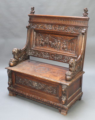 Schoolbred, a Victorian carved oak settle, the back carved figures with hinged lid to the seat 53"h x 42"w x 20"d 