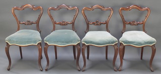 A set of 4 Victorian rosewood balloon back dining chairs with carved mid rails and seats of serpentine outline, raised on cabriole supports 