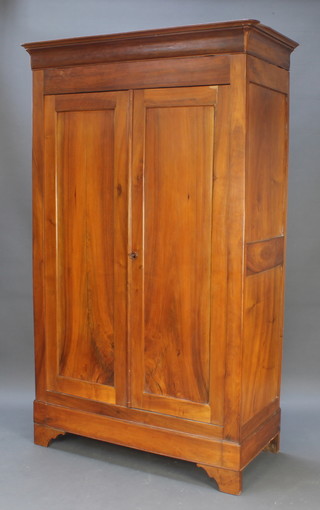 A walnut armoire with moulded cornice, fitted shelves enclosed by panelled doors 83"h x 50 1/2"w x 23"d 