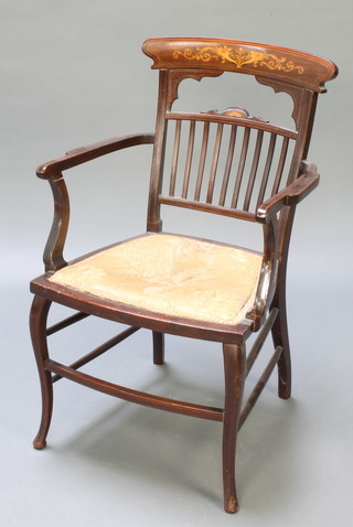 An Edwardian inlaid mahogany open arm carver chair with stick and bar back and upholstered seat, raised on turned supports 