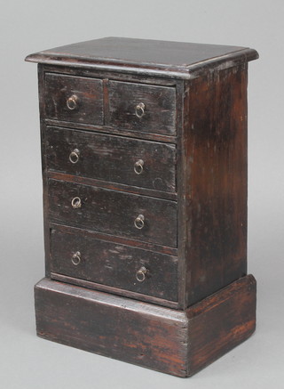 A Victorian stained pine "apprentice" chest of 2 short and 3 long drawers raised on a platform base 13"h x 8 1/2w x 5 1/2d 