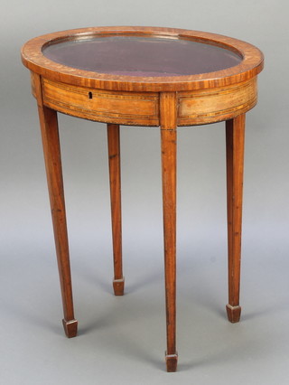 A 19th Century oval inlaid mahogany bijouterie table with plush interior and hinged lid, raised on square tapering supports ending in spade feet 28"h x 23"w x 18"d 