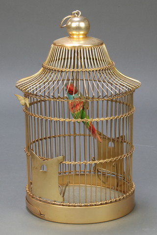 A metal bird cage containing a wooden parrot 17"h 